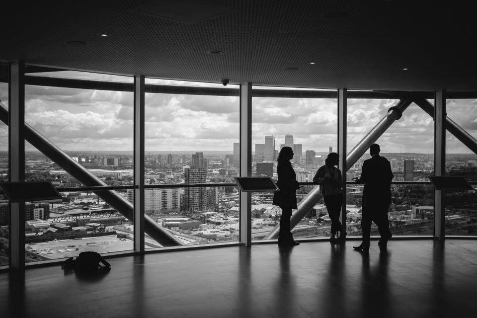 Colleagues in a discussion inside a bright office meeting space
