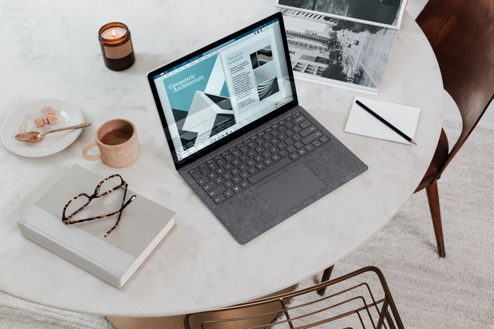 Employee working on a laptop at a clean home office desk